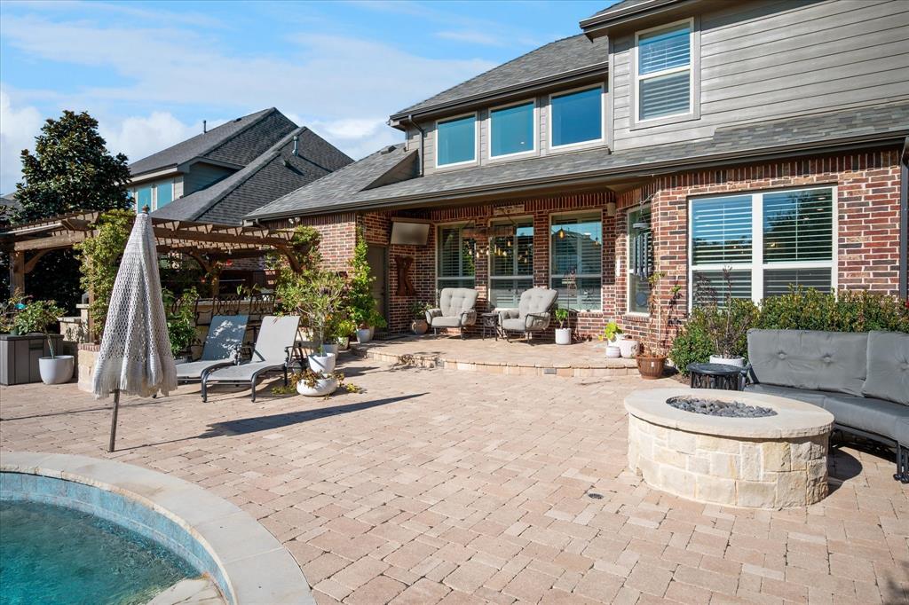 2880 Redfern Drive Trophy Club, TX 76262 - Photo 31 of 40 a view of a patio with table and chairs potted plants and floor to ceiling window