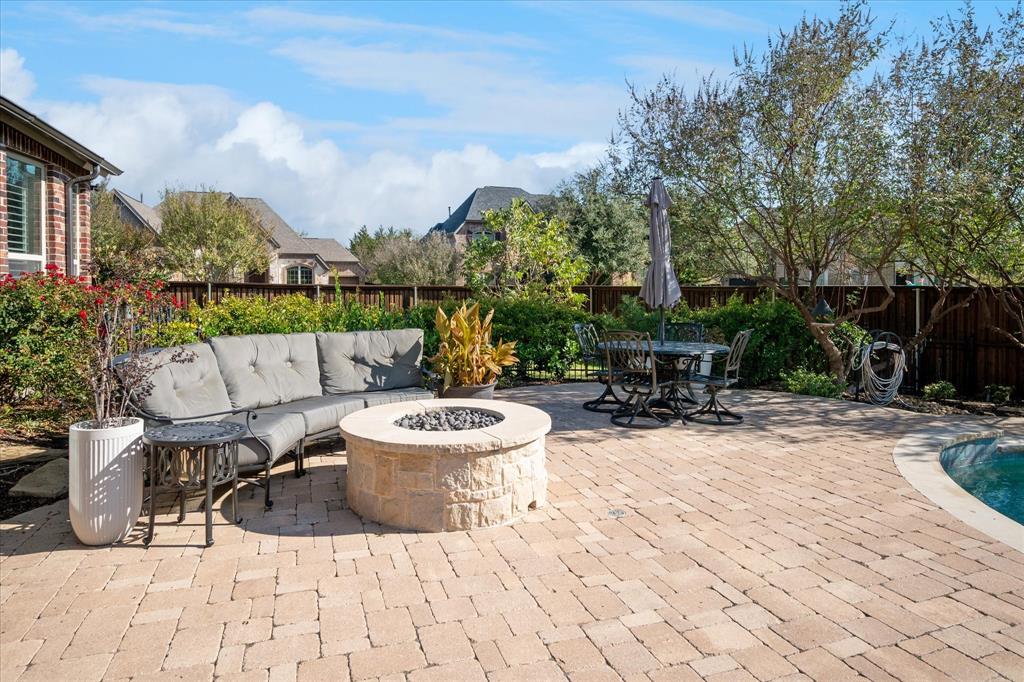 2880 Redfern Drive Trophy Club, TX 76262 - Photo 32 of 40 a view of a patio with dining table and chairs with wooden fence