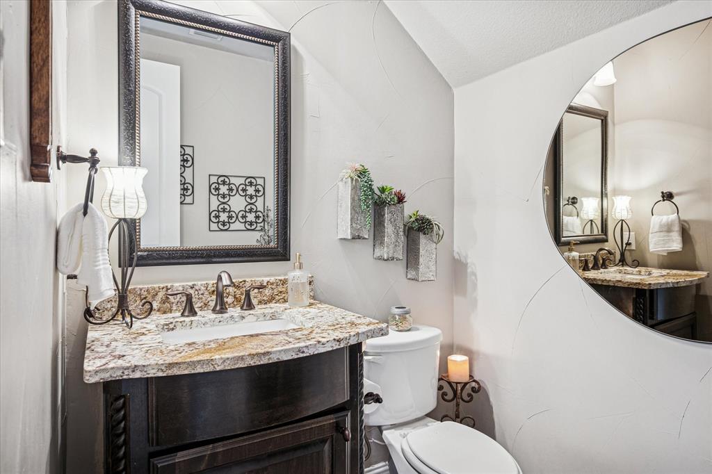 2880 Redfern Drive Trophy Club, TX 76262 - Photo 8 of 40 a bathroom with a granite countertop toilet sink and mirror