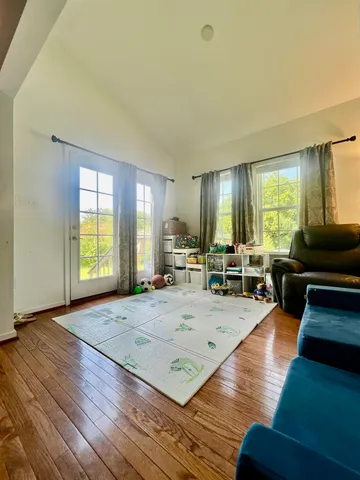 a living room with furniture window and wooden floor