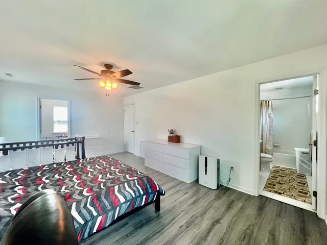 a bedroom with a bed and a desk