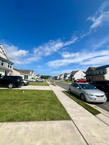 a view of a terrace with lawn chairs fire pit and yard