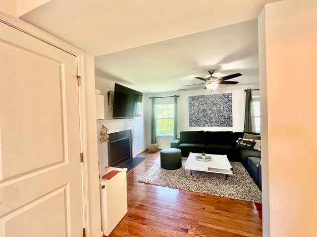a living room with furniture a fireplace and a flat screen tv