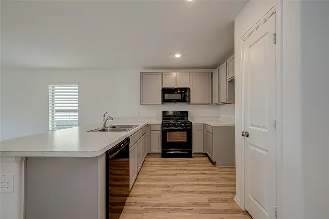 a kitchen with a sink stove and refrigerator