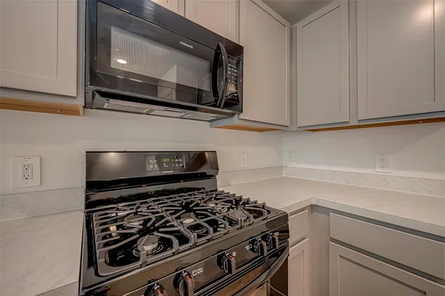 a stove top oven sitting inside of a kitchen