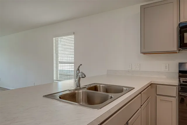 a kitchen with a sink and a microwave