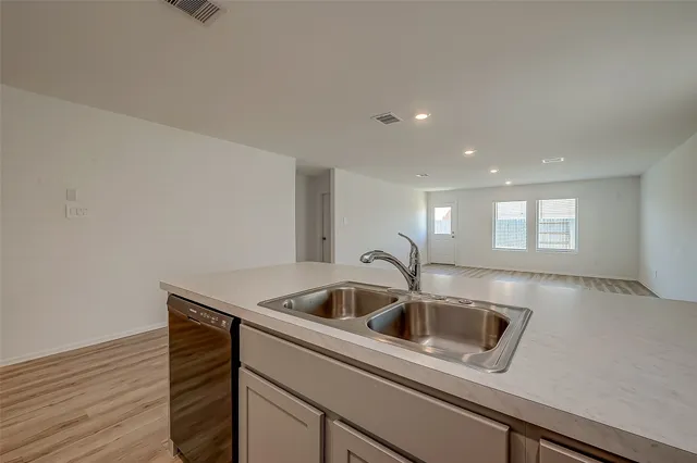a kitchen with a sink and cabinets