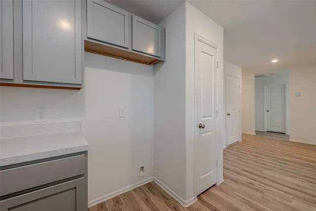 a view of a room with wooden floor
