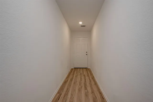 a view of a room with wooden floor and sink