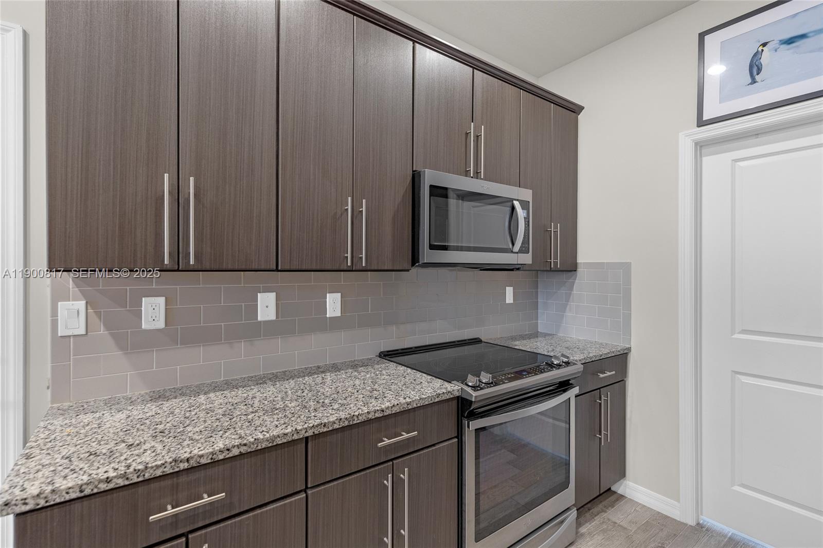 4810 Eucalyptus Drive, Unit 3 Hollywood, FL 33021 - Photo 12 of 32 a kitchen with granite countertop wood cabinets and a stove top oven