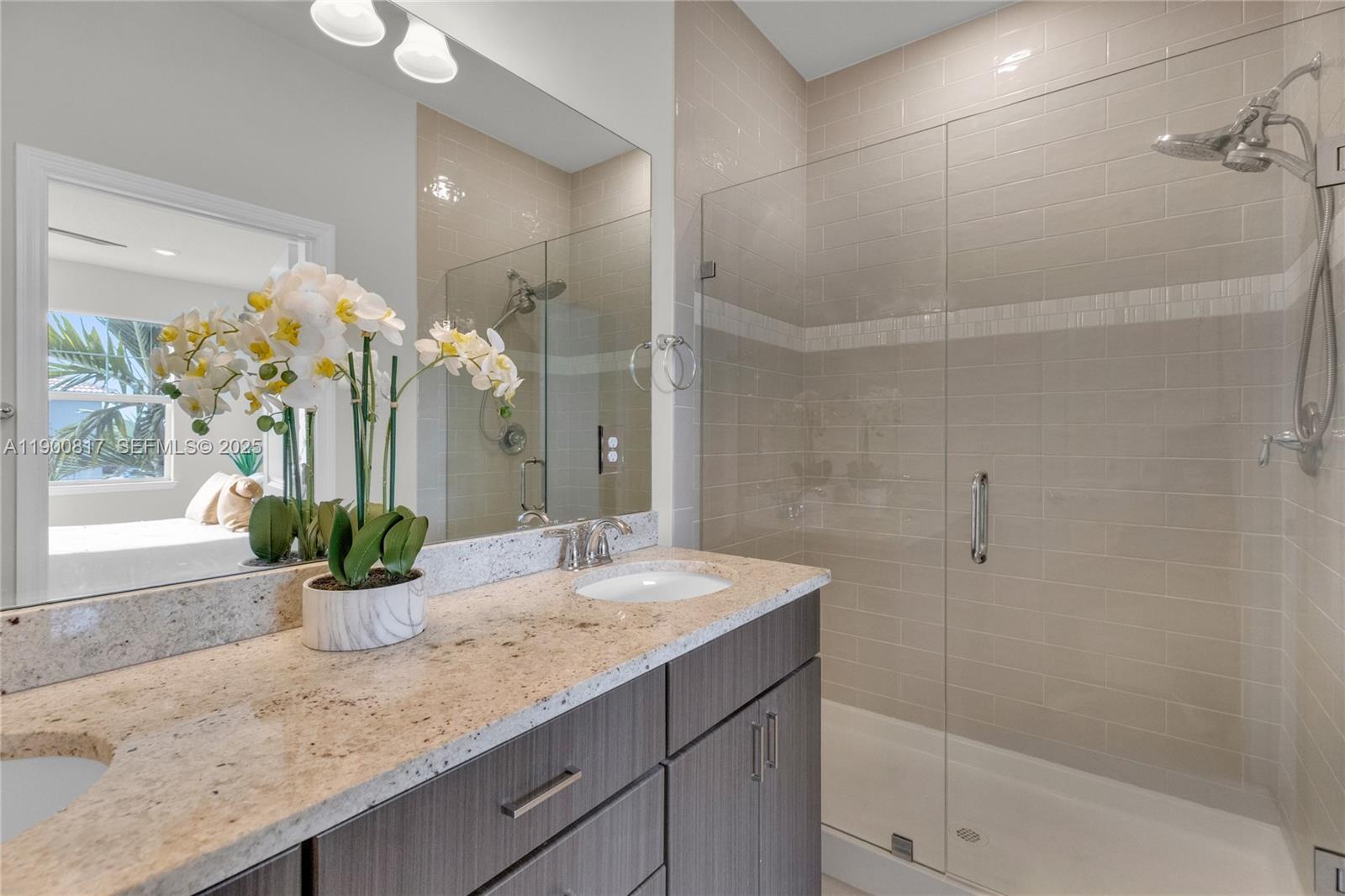 4810 Eucalyptus Drive, Unit 3 Hollywood, FL 33021 - Photo 20 of 32 a bathroom with a granite countertop sink a mirror and a shower
