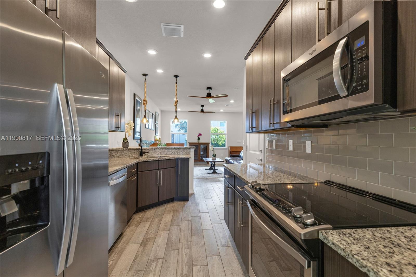 4810 Eucalyptus Drive, Unit 3 Hollywood, FL 33021 - Photo 7 of 32 a kitchen with stainless steel appliances granite countertop a stove a sink and a refrigerator