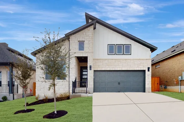a front view of a house with a yard