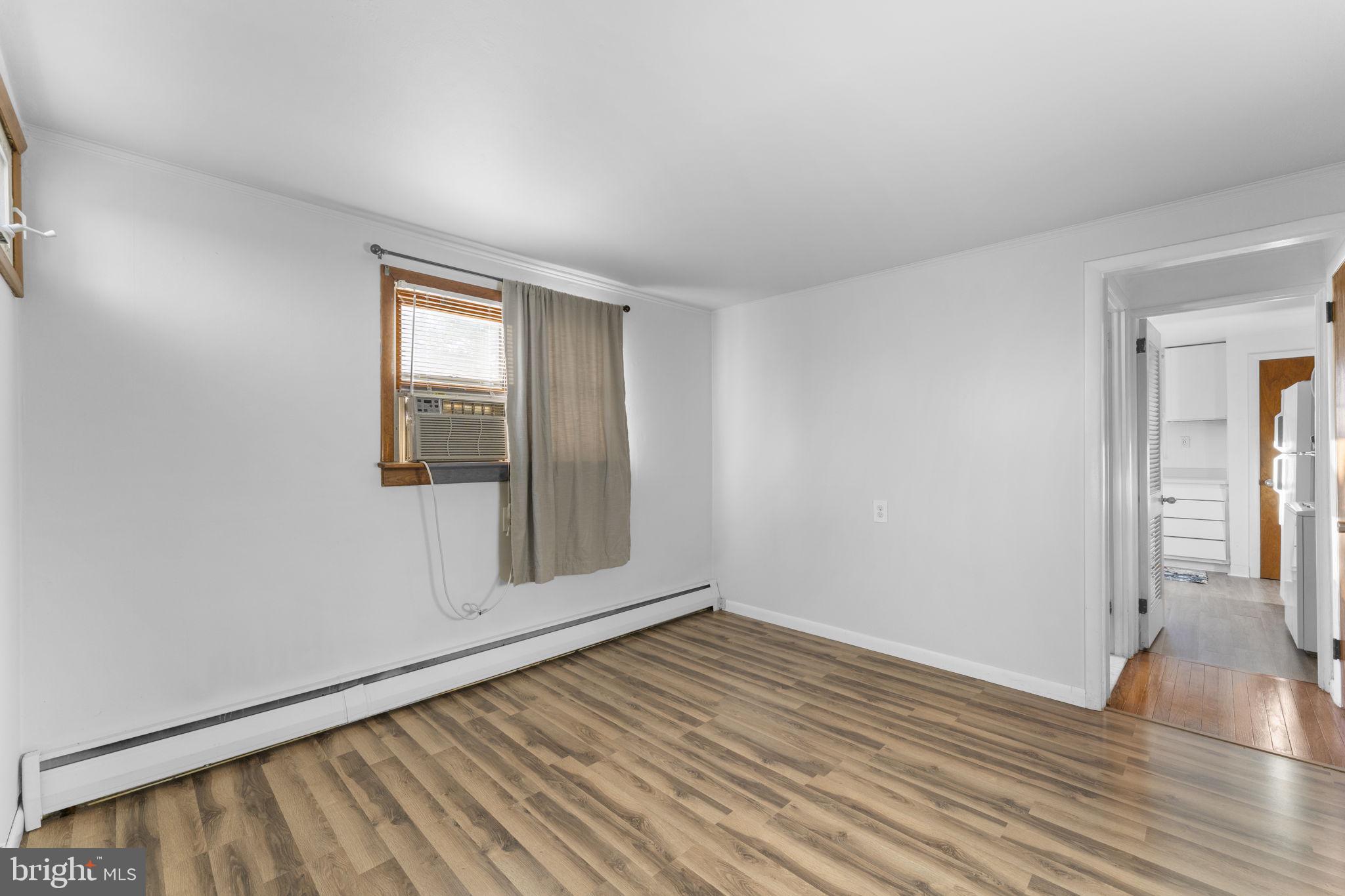 225 Pershing Avenue, Unit A Horsham, PA 19044 - Photo 15 of 19 wooden floor in an empty room with a window