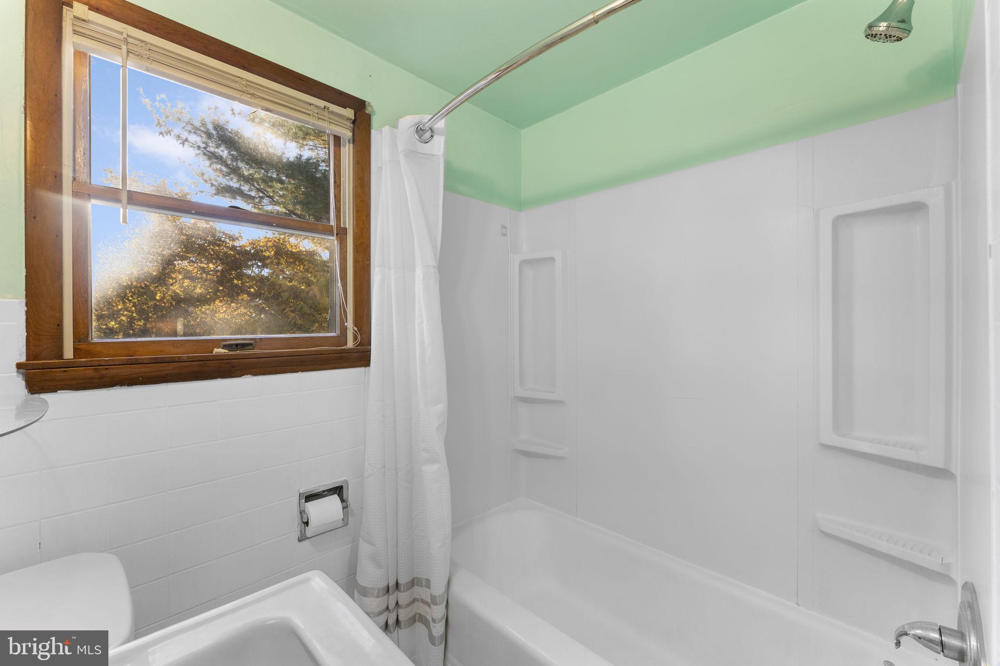 225 Pershing Avenue, Unit A Horsham, PA 19044 - Photo 19 of 19 a bathroom with a painting on the wall and a toilet