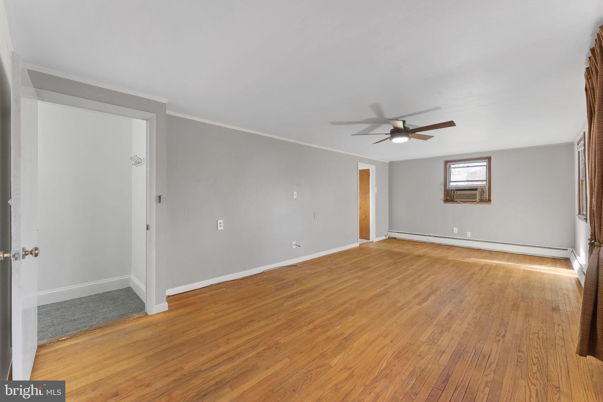 225 Pershing Avenue, Unit A Horsham, PA 19044 - Photo 8 of 19 a view of an empty room with wooden floor and a window