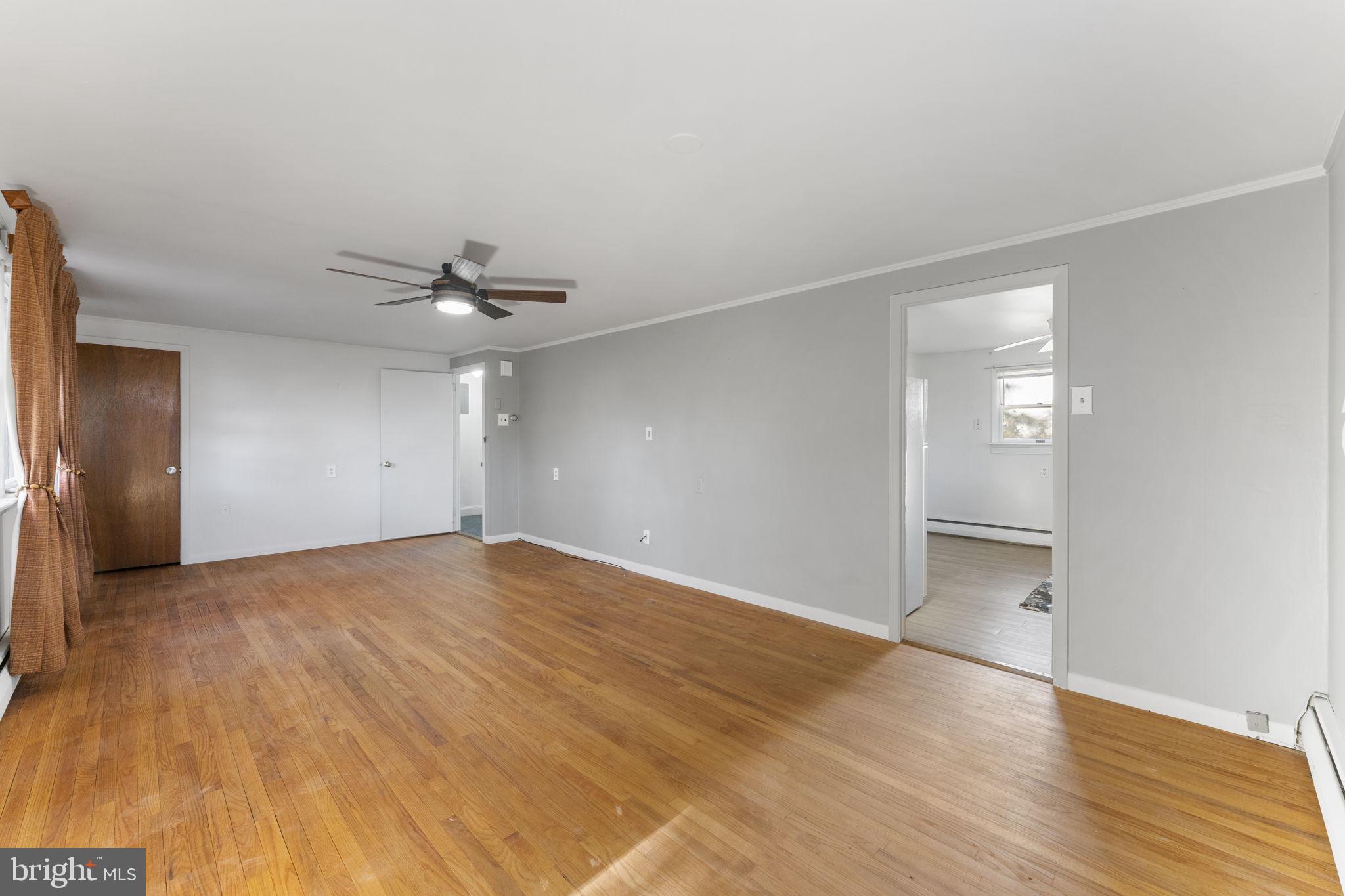 225 Pershing Avenue, Unit A Horsham, PA 19044 - Photo 9 of 19 an empty room with wooden floor and windows
