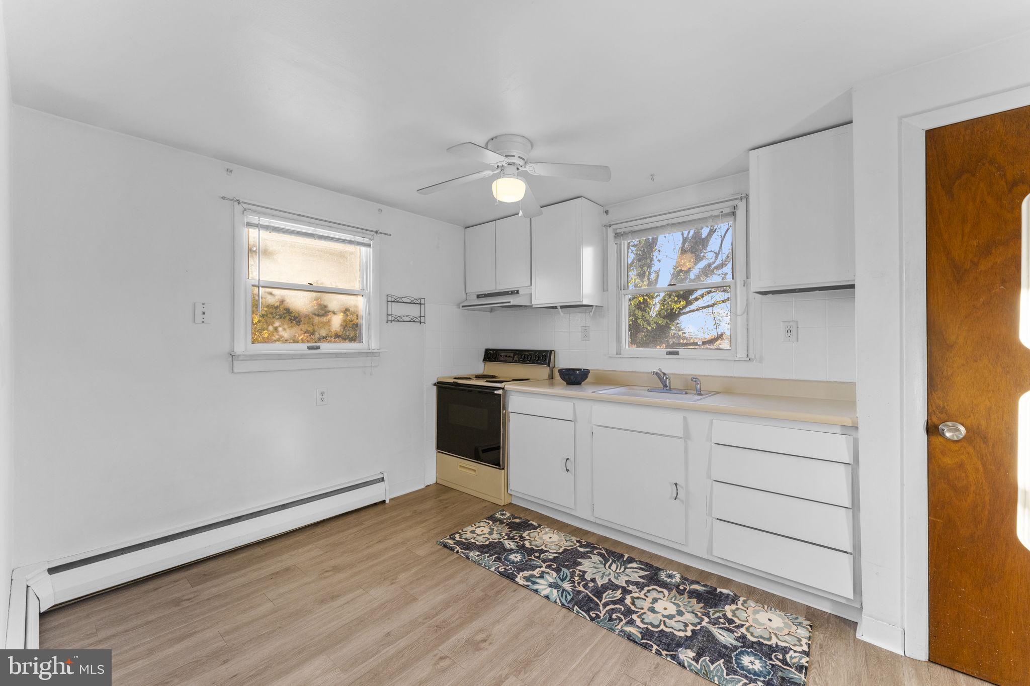 225 Pershing Avenue, Unit A Horsham, PA 19044 - Photo 10 of 19 a kitchen with granite countertop white cabinets and white appliances
