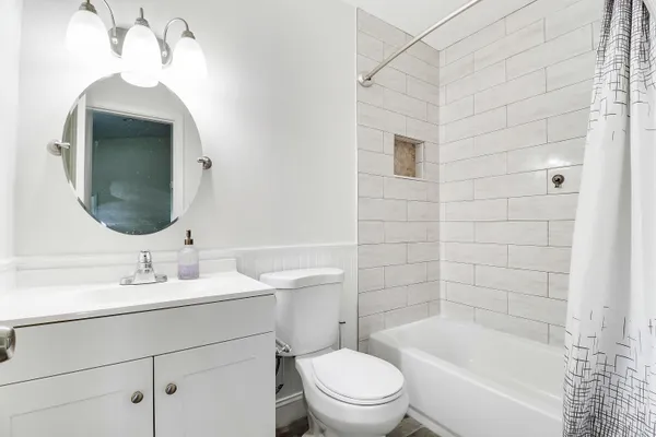 a bathroom with a sink toilet and shower