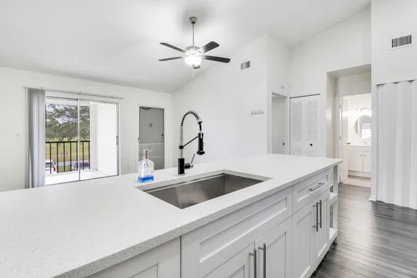 a kitchen with a sink and a refrigerator
