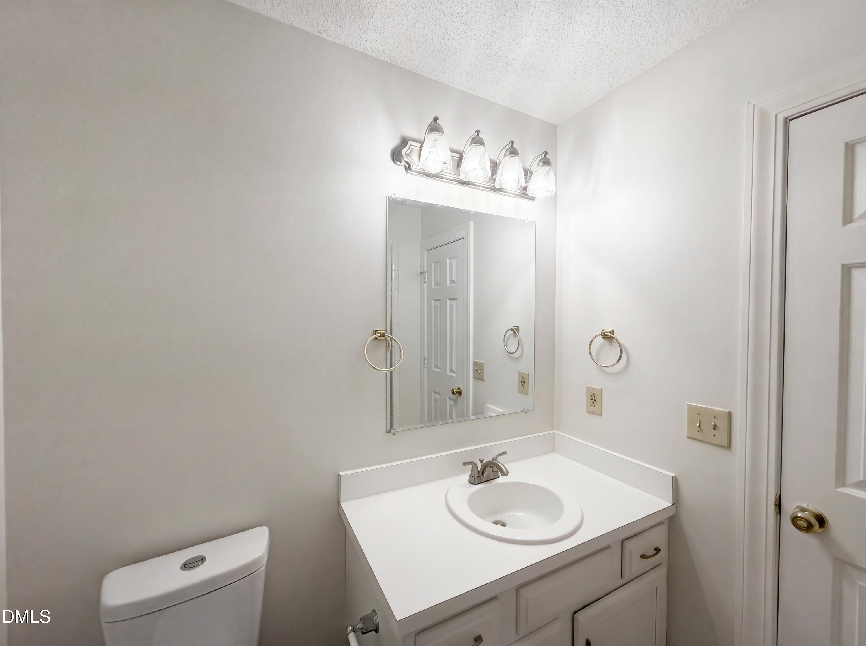 3921 Iron Horse Road Raleigh, NC 27616 - Photo 12 of 20 a bathroom with a sink vanity and a mirror