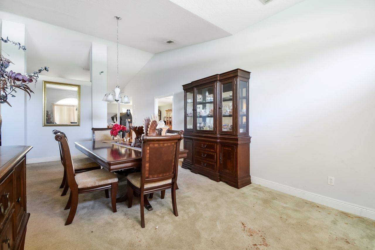 46 Riddle Drive Palm Coast, FL 32164 - Photo 13 of 20 a dining room with a wooden table and chairs