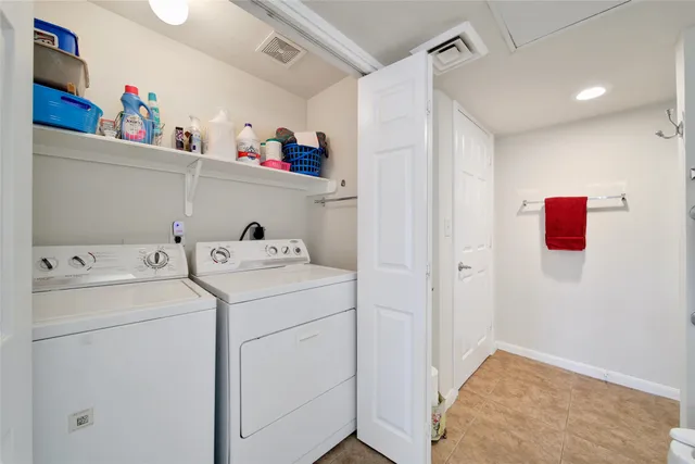a view of storage and utility room with washer and dryer