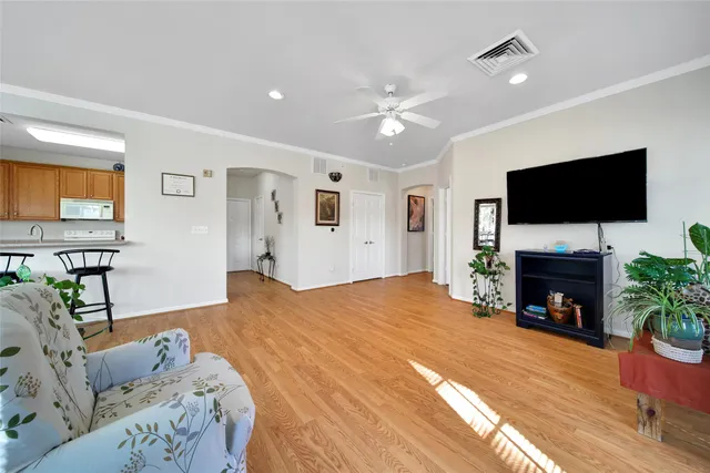 a spacious bedroom with a bed and a flat screen tv