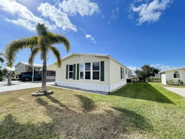 a kitchen with stainless steel appliances granite countertop a refrigerator a stove and a sink