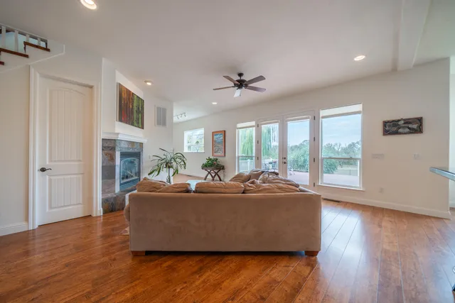 a kitchen with stainless steel appliances a refrigerator and wooden floor