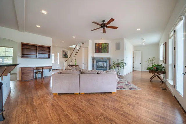 a kitchen with stainless steel appliances granite countertop a sink cabinets and wooden floor