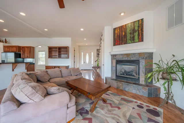 a kitchen with stainless steel appliances kitchen island granite countertop wooden floors and cabinets