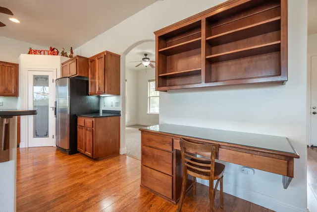 a kitchen with stainless steel appliances granite countertop a refrigerator and a stove top oven