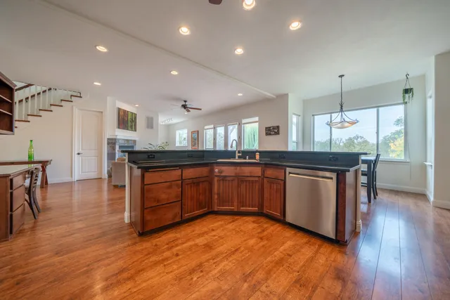 a close view of wooden cabinets and a microwave oven on the wall