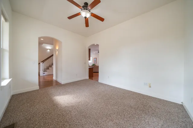 a view of a livingroom with a ceiling fan and window