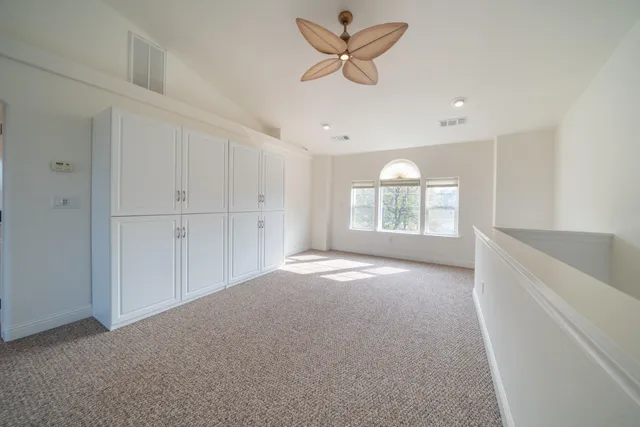 a view of a patio with wooden floor table and chairs