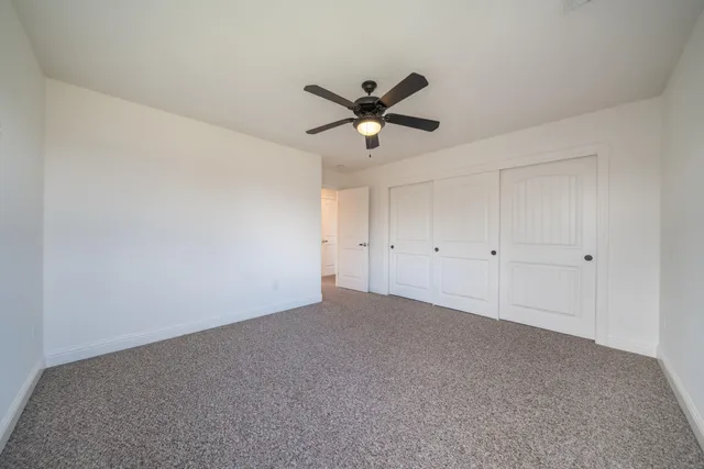 a view of a house with a big yard and a large tree