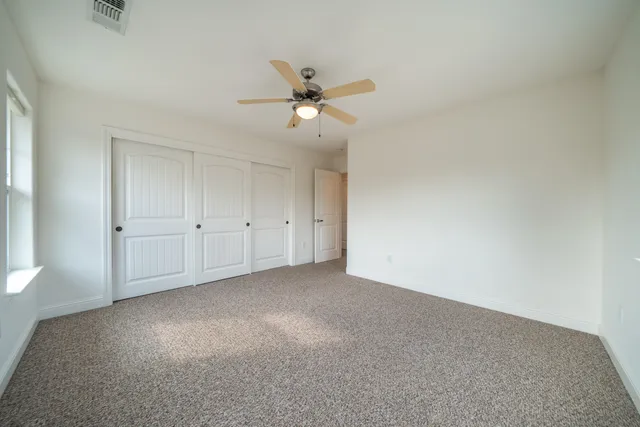 a front view of a house with a yard and trees