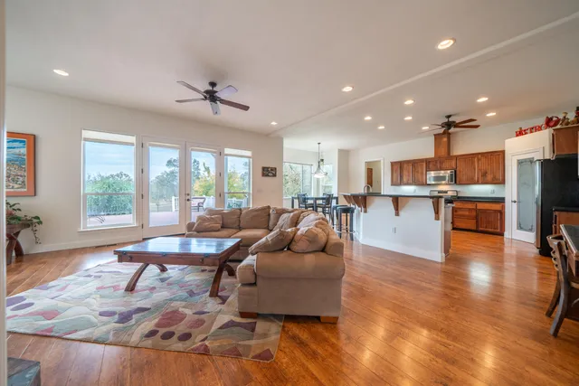 a large kitchen with stainless steel appliances granite countertop a refrigerator and a sink