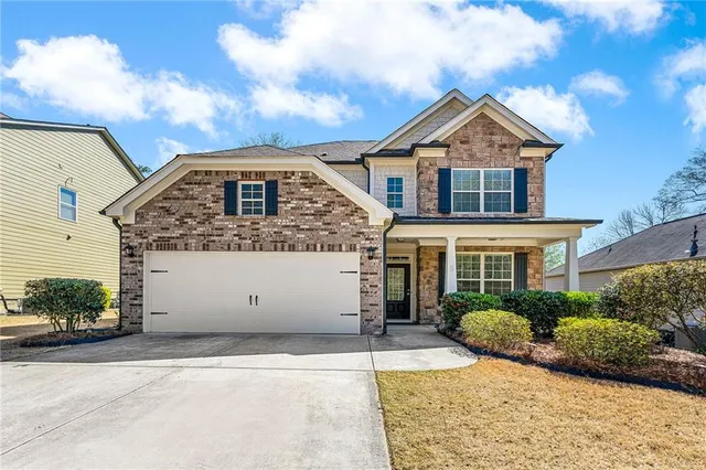 a front view of a house with a yard