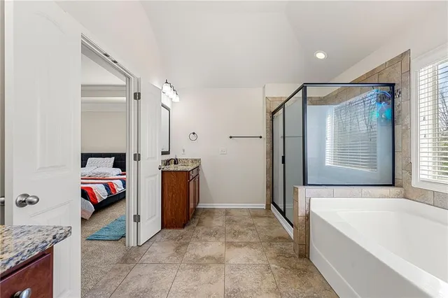 a bathroom with a tub sink and mirror