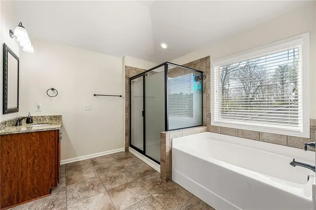 a bathroom with a bathtub and a shower
