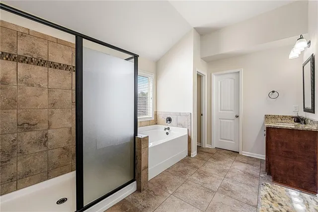 a spacious bathroom with a bathtub and a shower