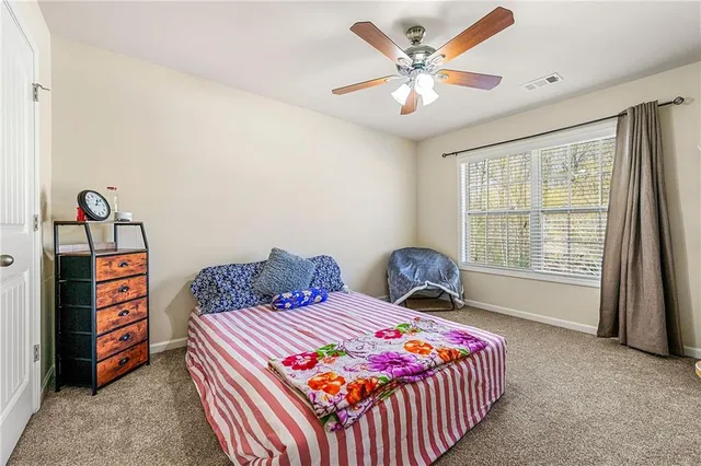 a bedroom with two beds and a window