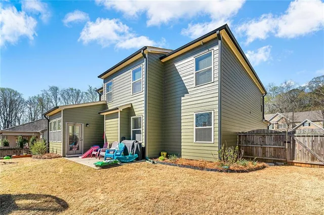 a view of a house with snow on the side of the road