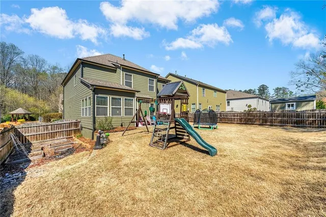 a view of a house with swimming pool and sitting area