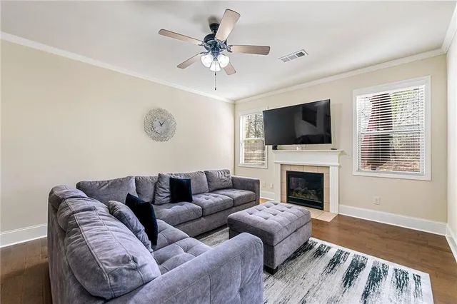 a living room with furniture a fireplace and a flat screen tv