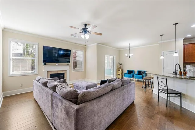 a living room with furniture flat screen tv and wooden floor