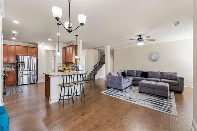 a living room with furniture and kitchen view