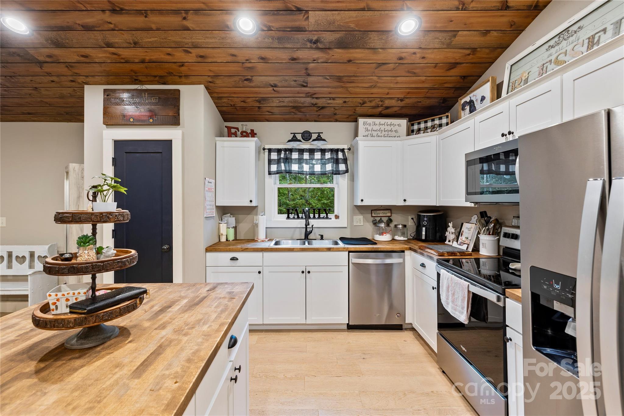 185 Ben Nevis Road Brevard, NC 28712 - Photo 12 of 42 a kitchen with stainless steel appliances granite countertop a stove refrigerator and cabinets